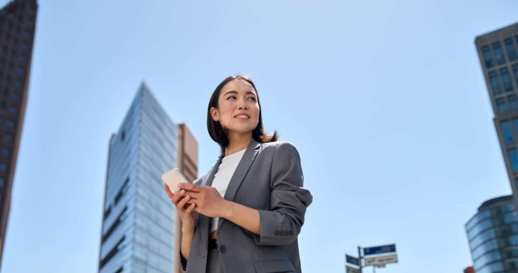 Business woman holding smartphone and using Citymesh mobile network