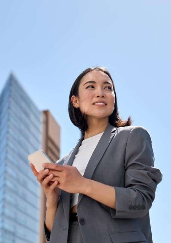 Business woman holding smartphone and using Citymesh mobile network
